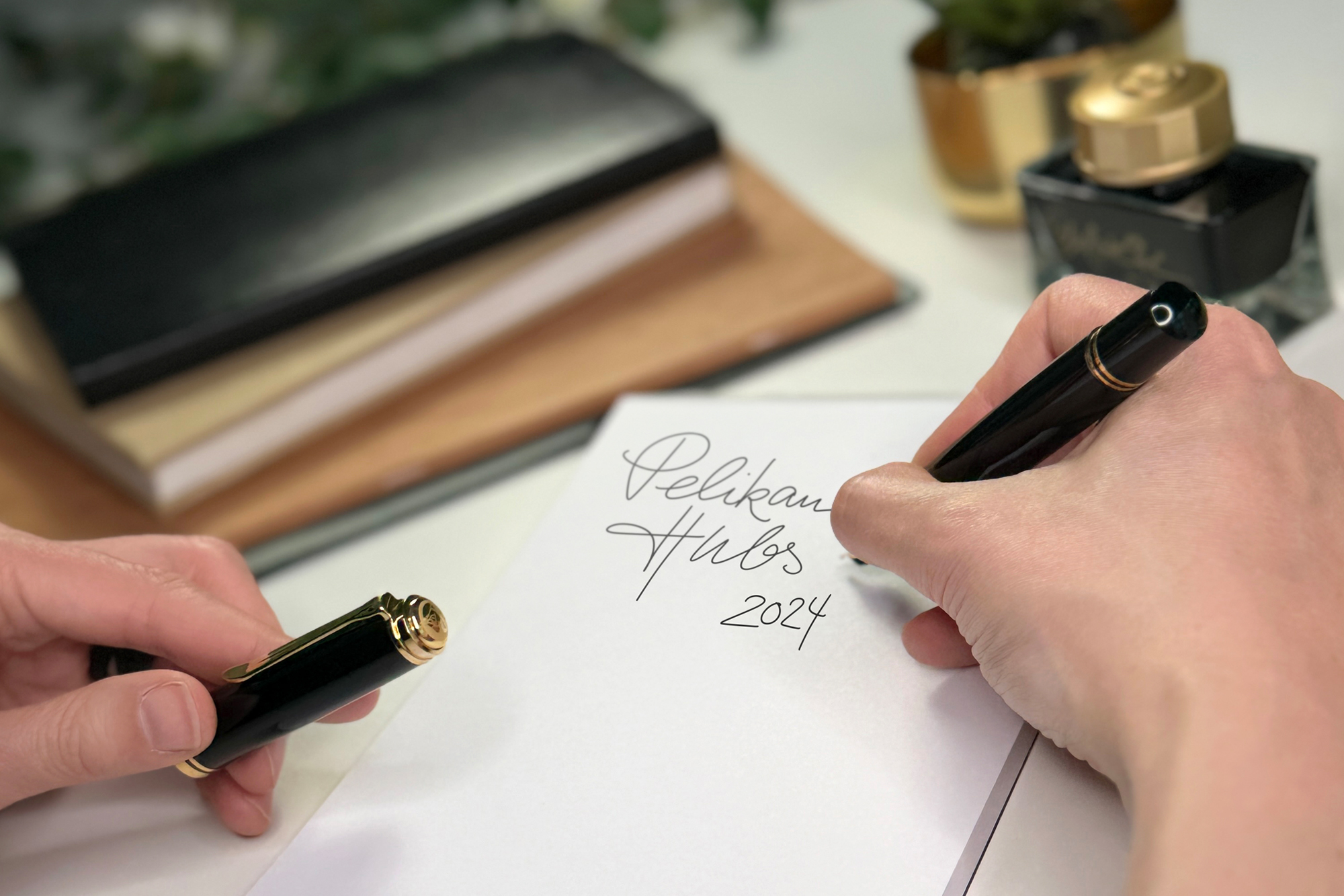 The Pelikan Hubs connect writing enthusiasts. A worldwide platform that unites knowledge and passion. Three People looking at fountain pens